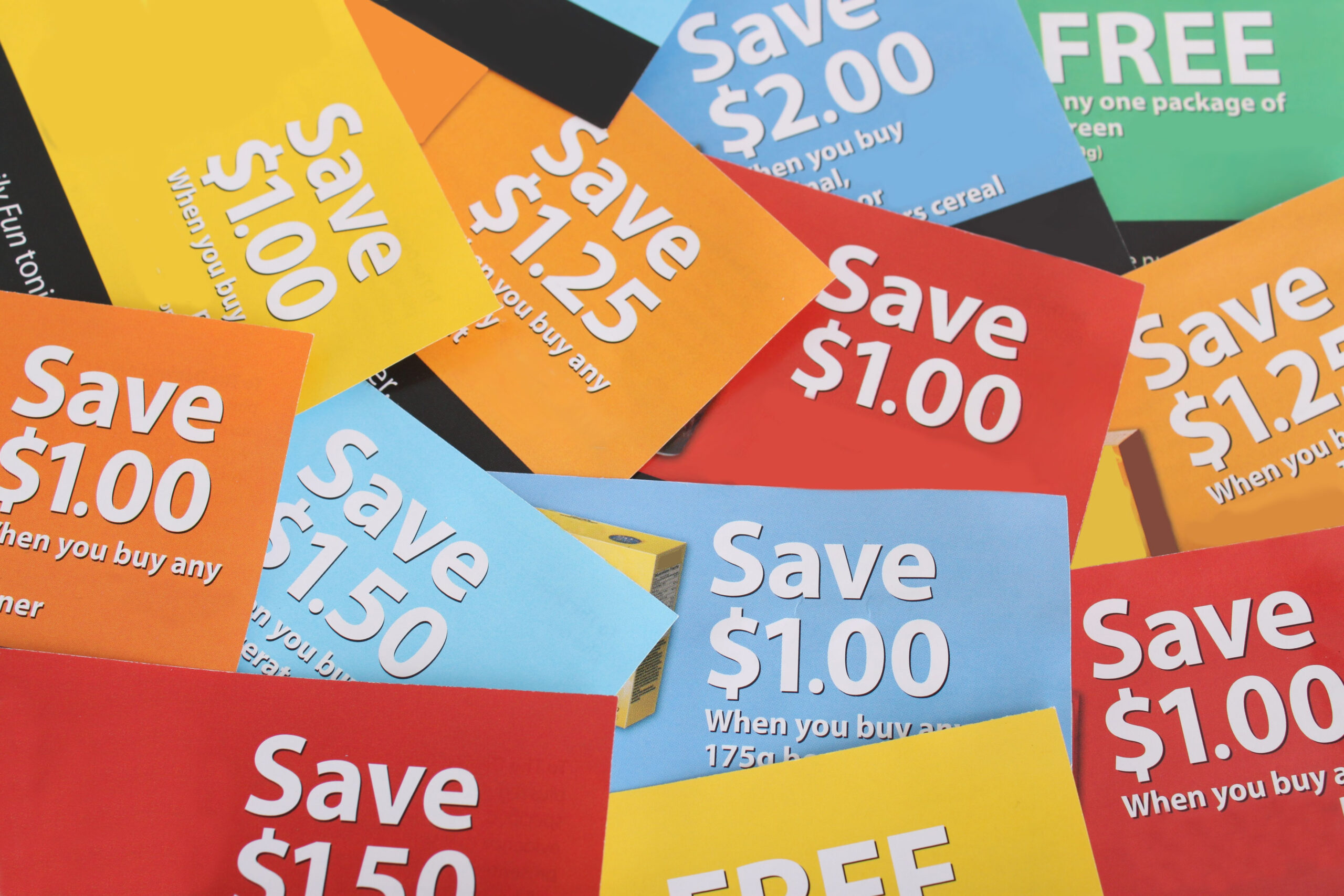 Cutting coupons in different colors, and price ranges from free to a few dollars